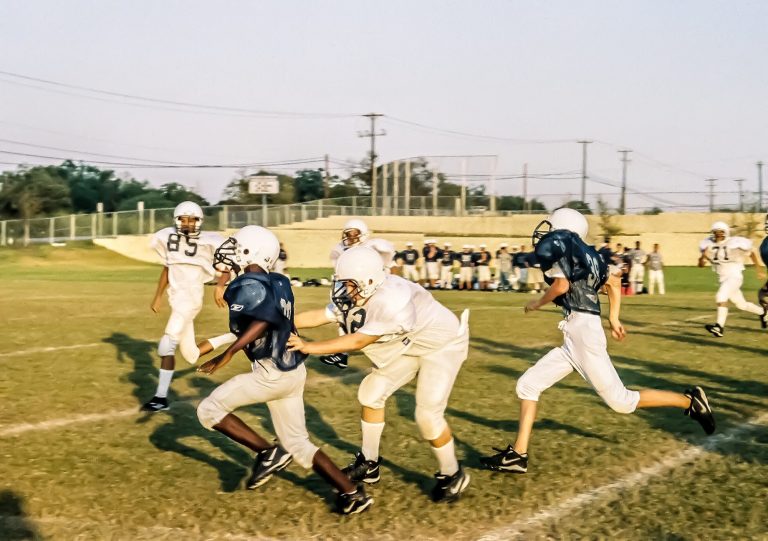 A high school football game in play.