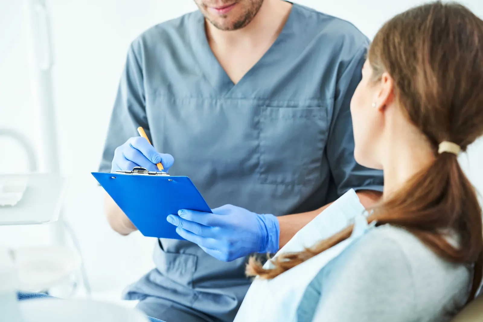Male dentist and woman in dentist office