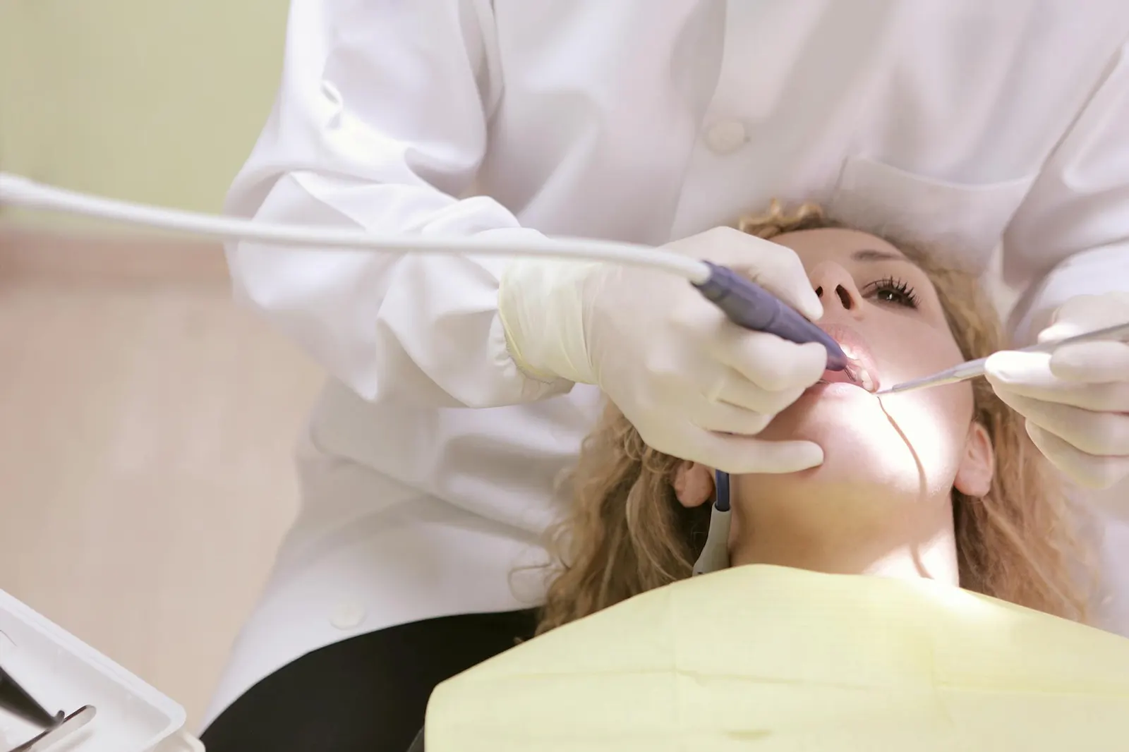 dentist working on woman s teeth